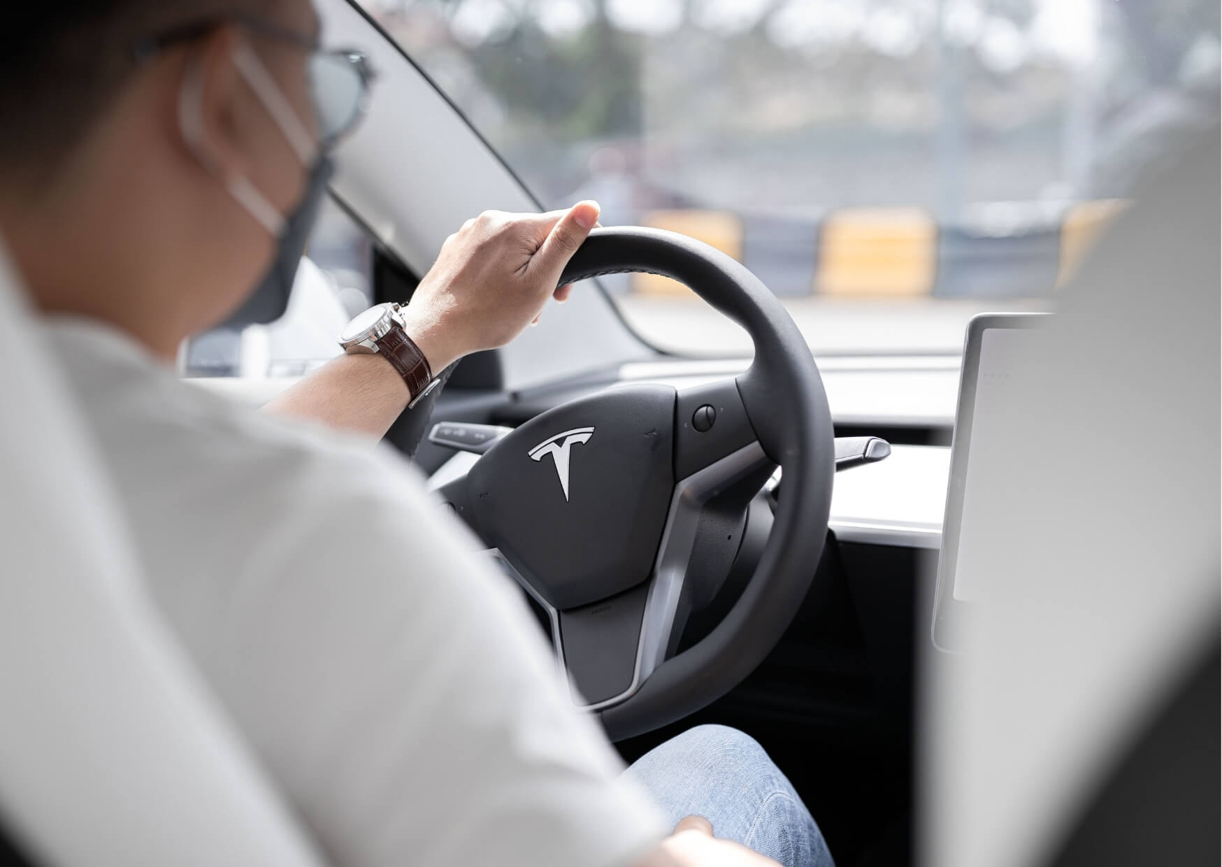 Driver holding a steering wheel, representing considerations for driving after a root canal, especially when sedation or pain medication is involved.