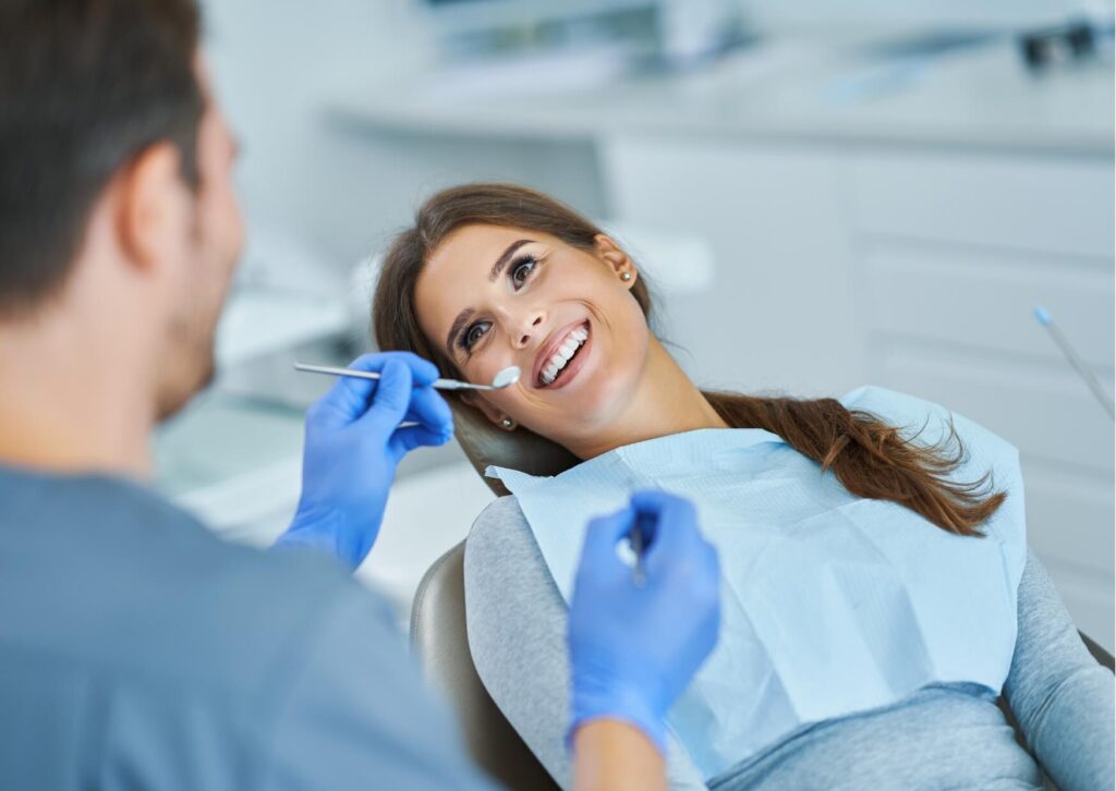 Patient smiling during a dental visit, illustrating recovery and common questions about whether it is safe to drive after a root canal procedure.