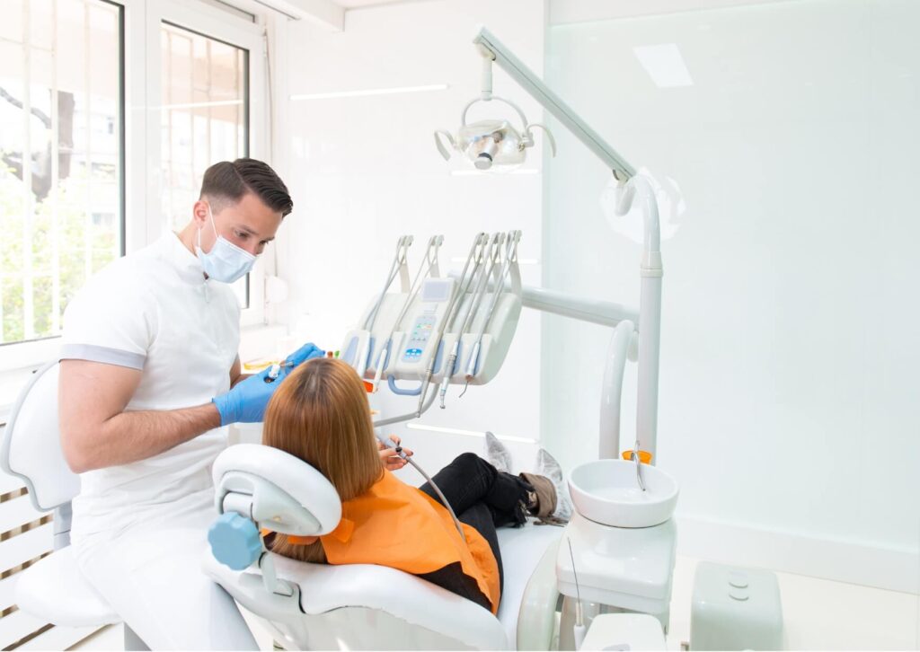 Dentist examining a patient with suspected cracked tooth symptoms during a comprehensive dental evaluation.