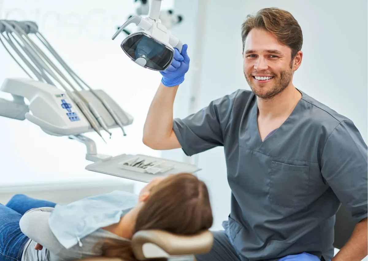 Dentist preparing a patient for treatment in a dental office offering sedation dentistry.