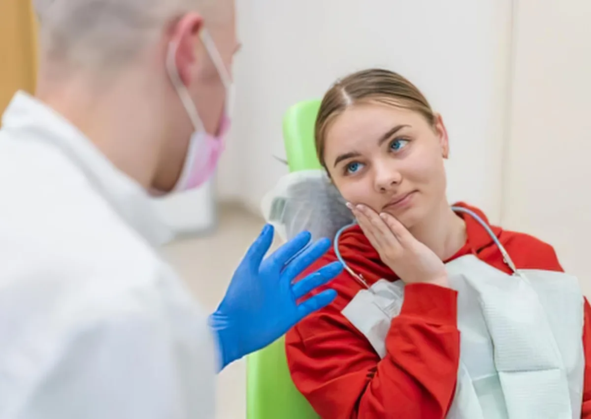 Patient discussing post-operative care with a dentist after dental implant surgery, including foods such as dairy to avoid.