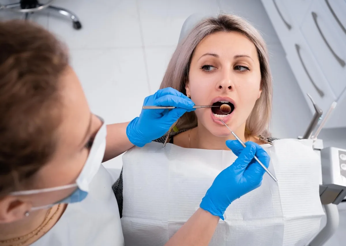 Dentist examining a patient’s teeth before applying dental sealants to help protect against cavities.